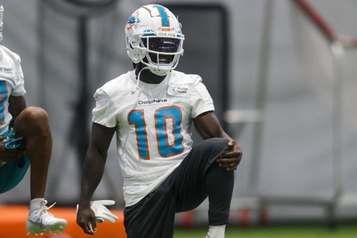 Miami Dolphins WR Tyreek Hill (10) stretches before drills.