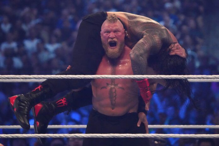 WWE superstar Brock Lesnar sets up Roman Reigns for his F5 finisher move.