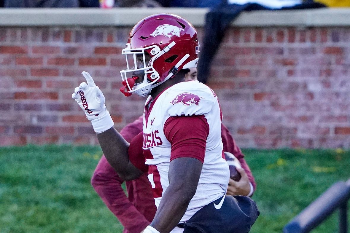 Arkansas Razorbacks RB Raheim Sanders (5) raises a finger in celebration after scoring a touchdown.