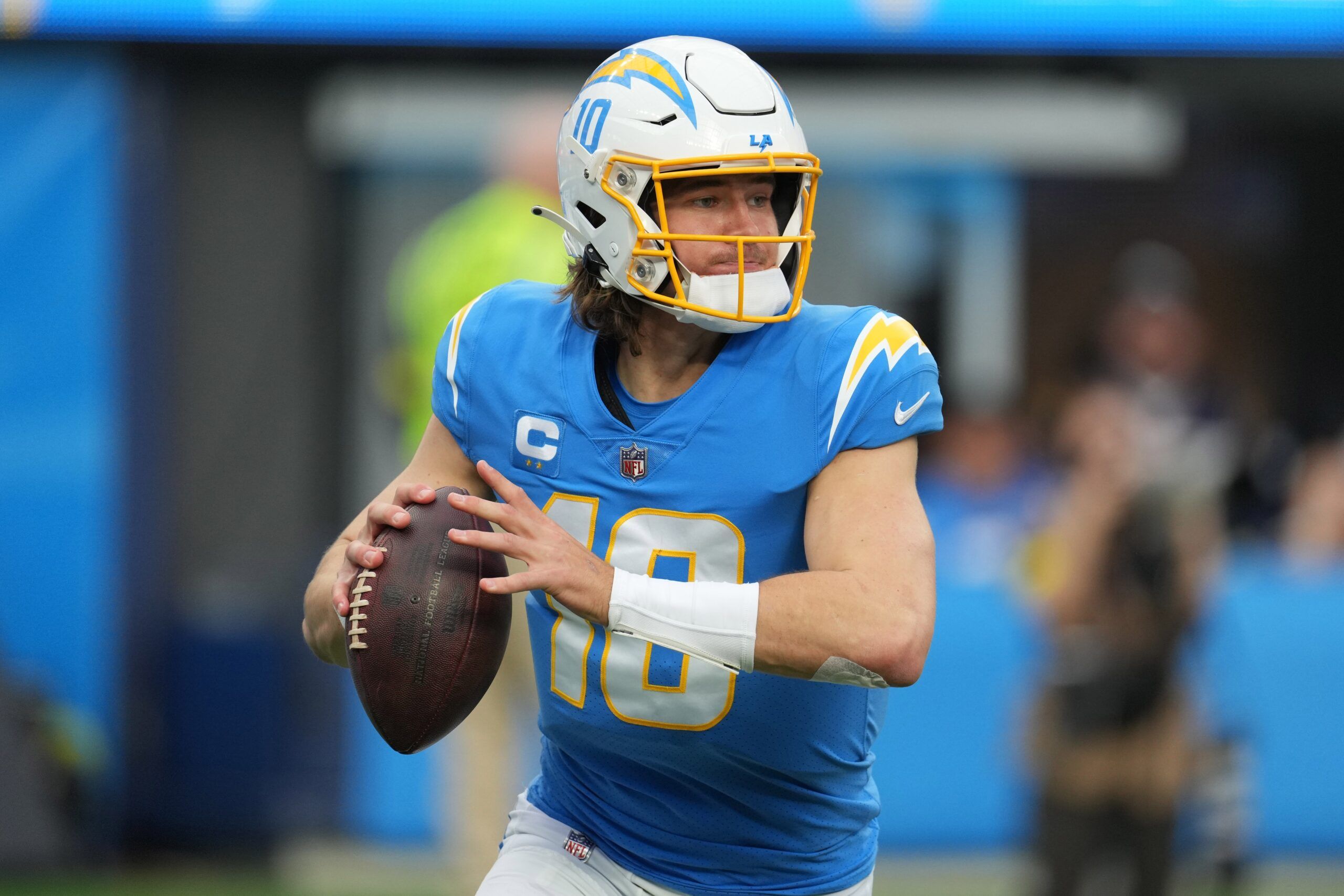 Los Angeles Chargers QB Justin Herbert (10) rolls out to pass.