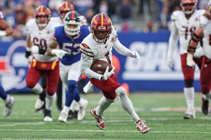 Washington Commanders wide receiver Jahan Dotson (1) runs up field on a touchdown reception.