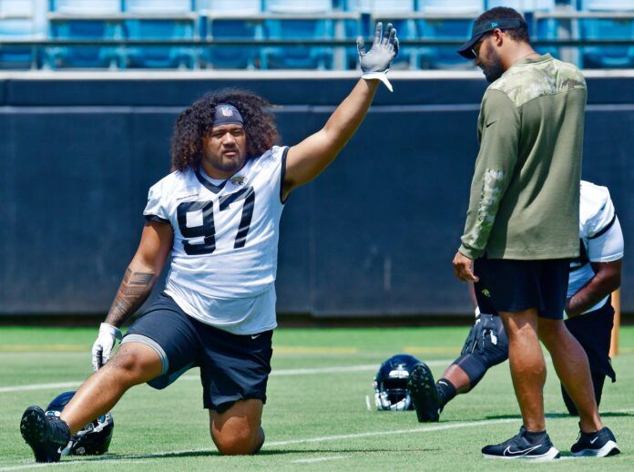 Jacksonville Jaguars defensive tackle Jay Tufele (97) talks with associate strength coach Kevin Maxen during the Jaguars rookie minicamp session.