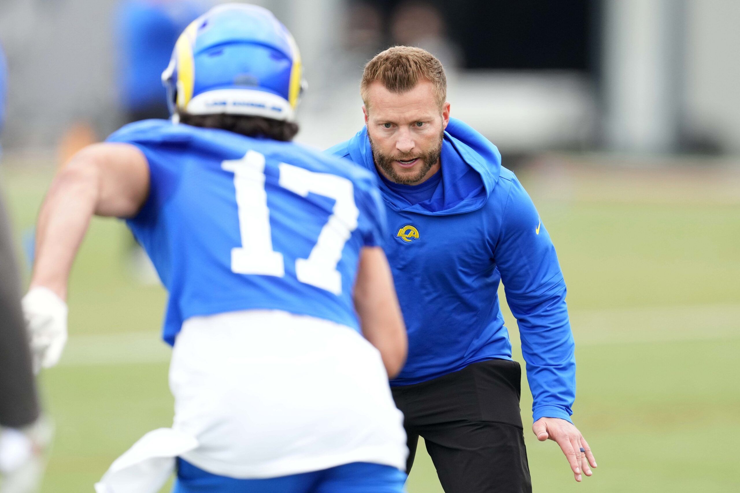 Los Angeles Rams WR Puka Nacua (17) runs a drill with head coach Sean McVay.