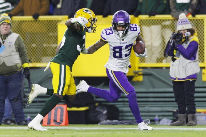 Minnesota Vikings WR Jalen Nailor (83) tries to break a tackle against the Green Bay Packers.