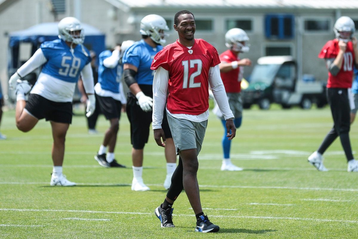 Detroit Lions QB Hendon Hooker (12) smiles during warmups in the team's minicamp.