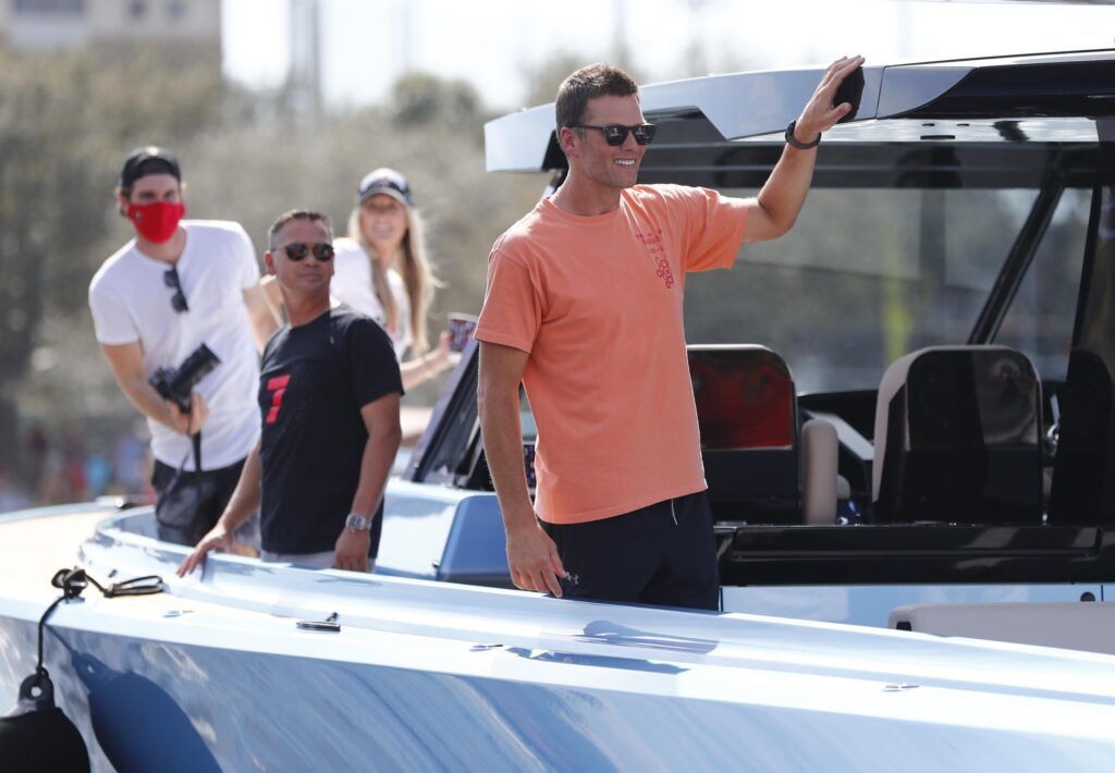 Tom Brady smiling on a boat shortly after the Tampa Bay Buccaneers won Super Bowl LV.