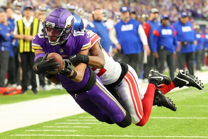 Minnesota Vikings WR Justin Jefferson (18) dives into the end zone against the New York Giants.