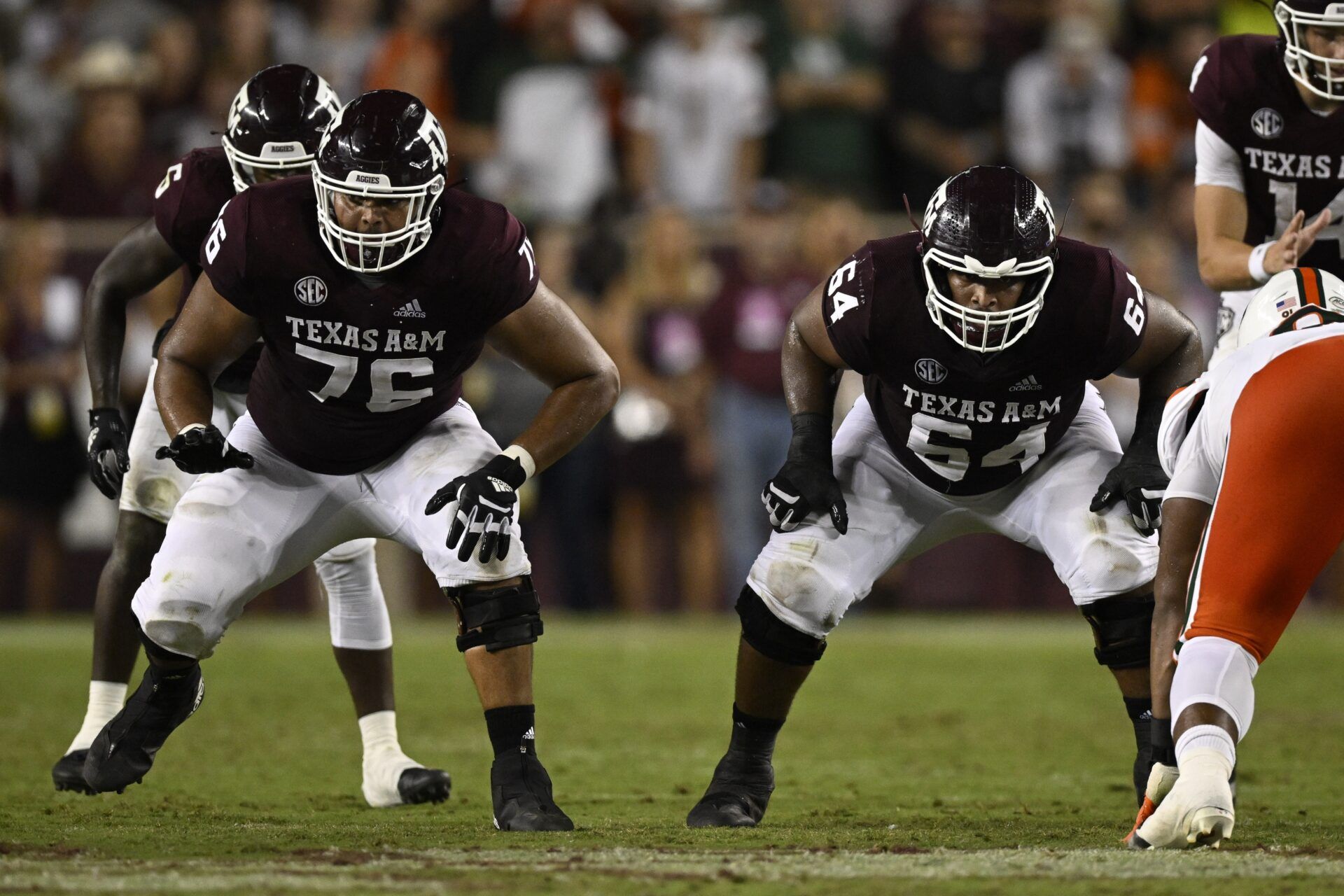 Texas A&M Aggies OL Reuben Fatheree II (76) and Layden Robinson (64) in action against the Miami Hurricanes.