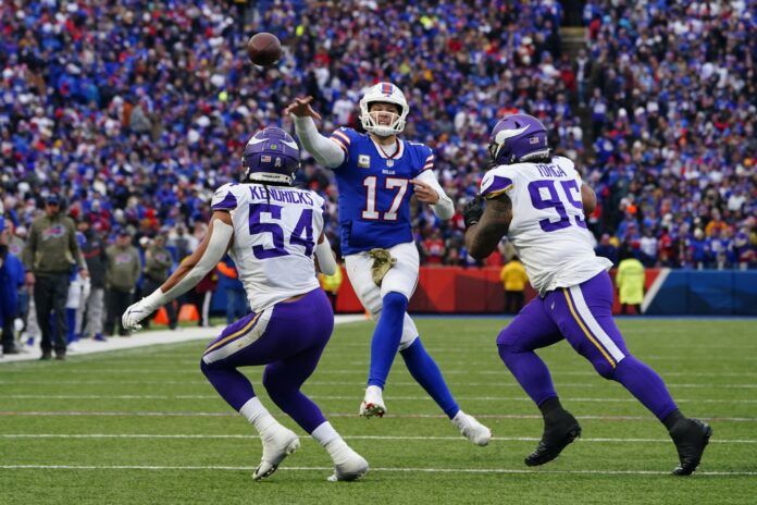 Minnesota Vikings DL Khyiris Tonga (95) and LB Eric Kendricks (54) chase Buffalo Bills QB Josh Allen (17).