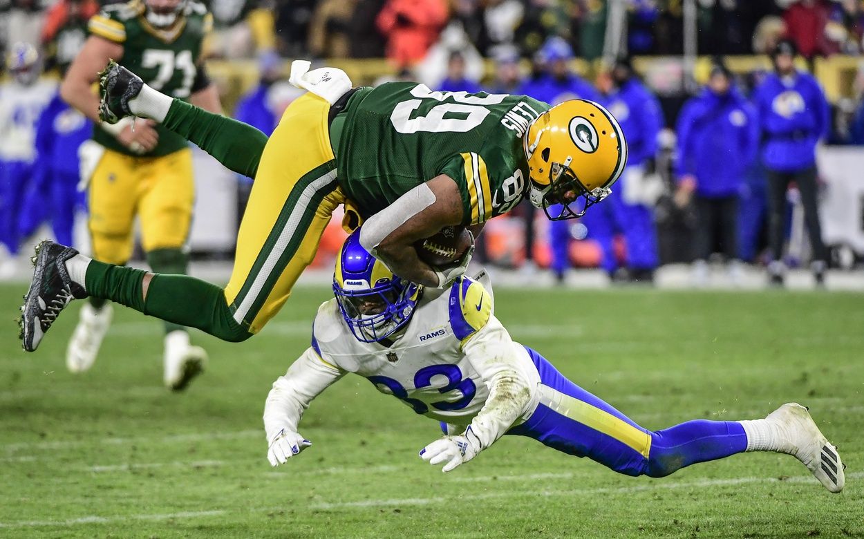 Green Bay Packers TE Marcedes Lewis (89) gets tackled by Los Angeles Rams S Nick Scott (33).