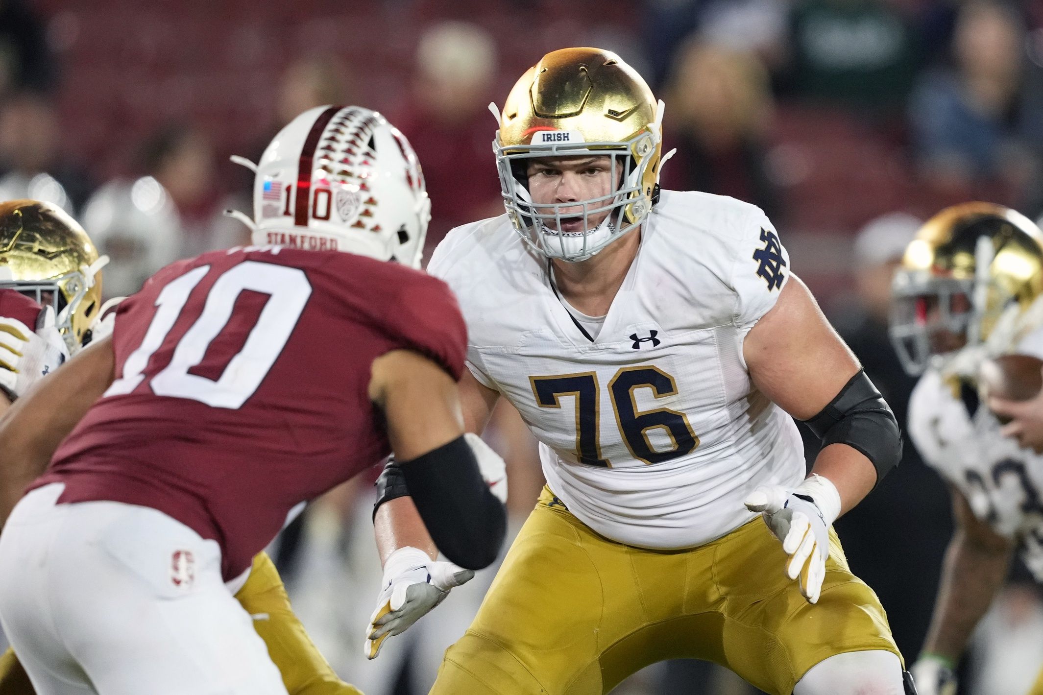 Joe Alt (76) blocks Stanford Cardinal linebacker Jordan Fox (10) during the fourth quarter at Stanford Stadium.