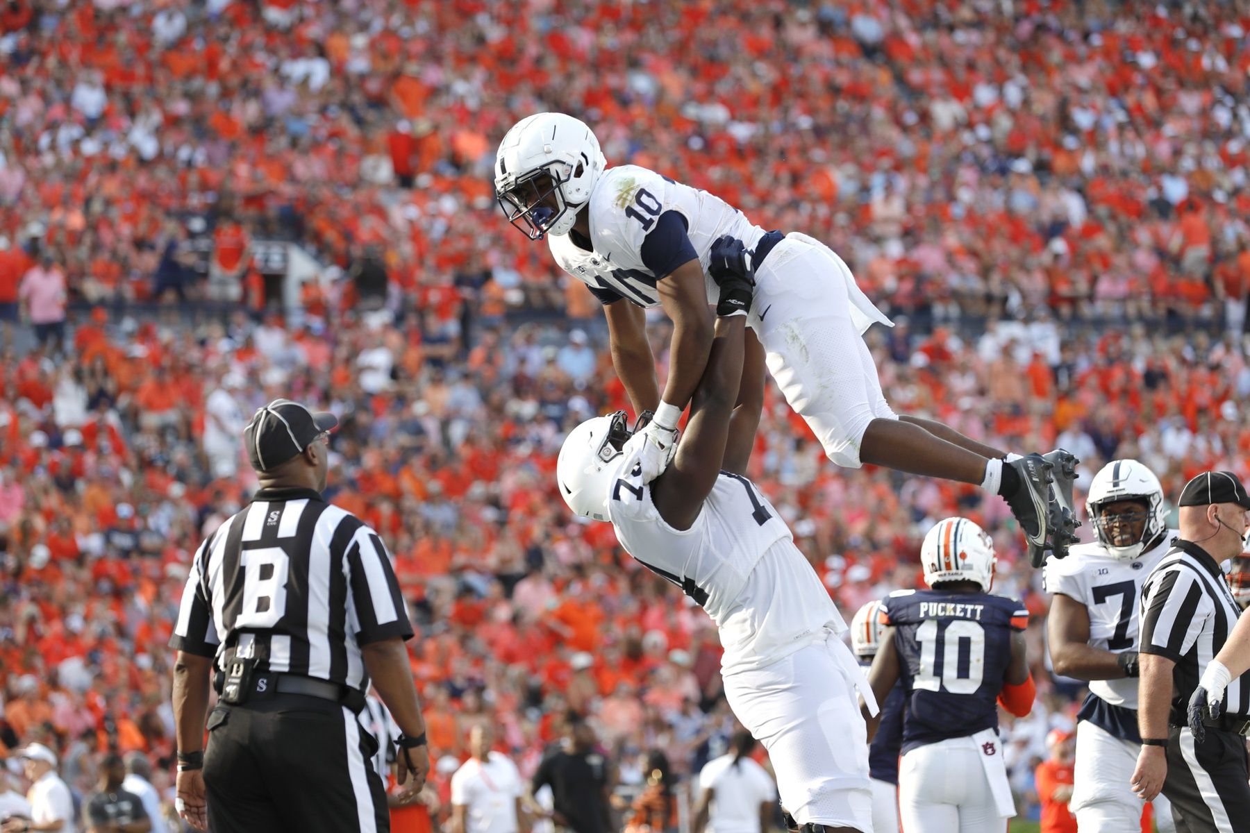 Nicholas Singleton (10) celebrates with offensive lineman Olumuyiwa Fashanu (74) after scoring a touchdown against the Auburn Tigers during the third quarter at Jordan-Hare Stadium.