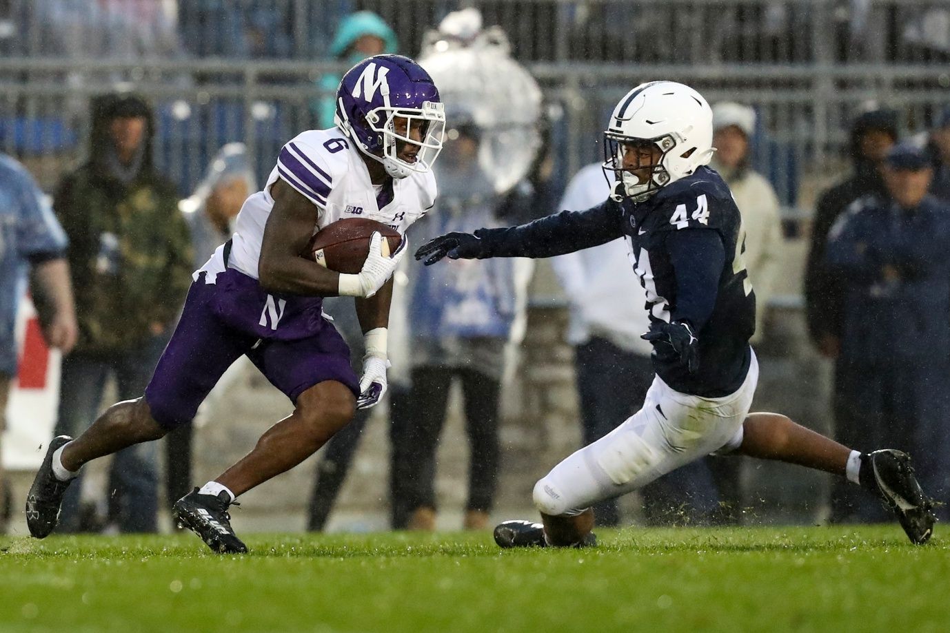 Malik Washington (6) runs the ball against Penn State Nittany Lions defensive end Chop Robinson (44) during the fourth quarter at Beaver Stadium.