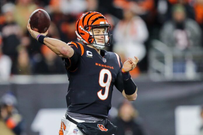 Joe Burrow (9) throws a pass against the Baltimore Ravens in the second half during a wild card game at Paycor Stadium.