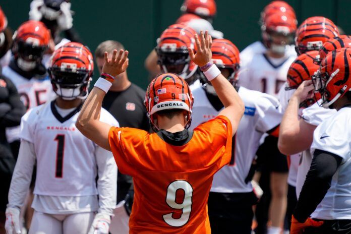 Joe Burrow (9) talks to the offense between reps during an off-season workout inside Paycor Stadium.