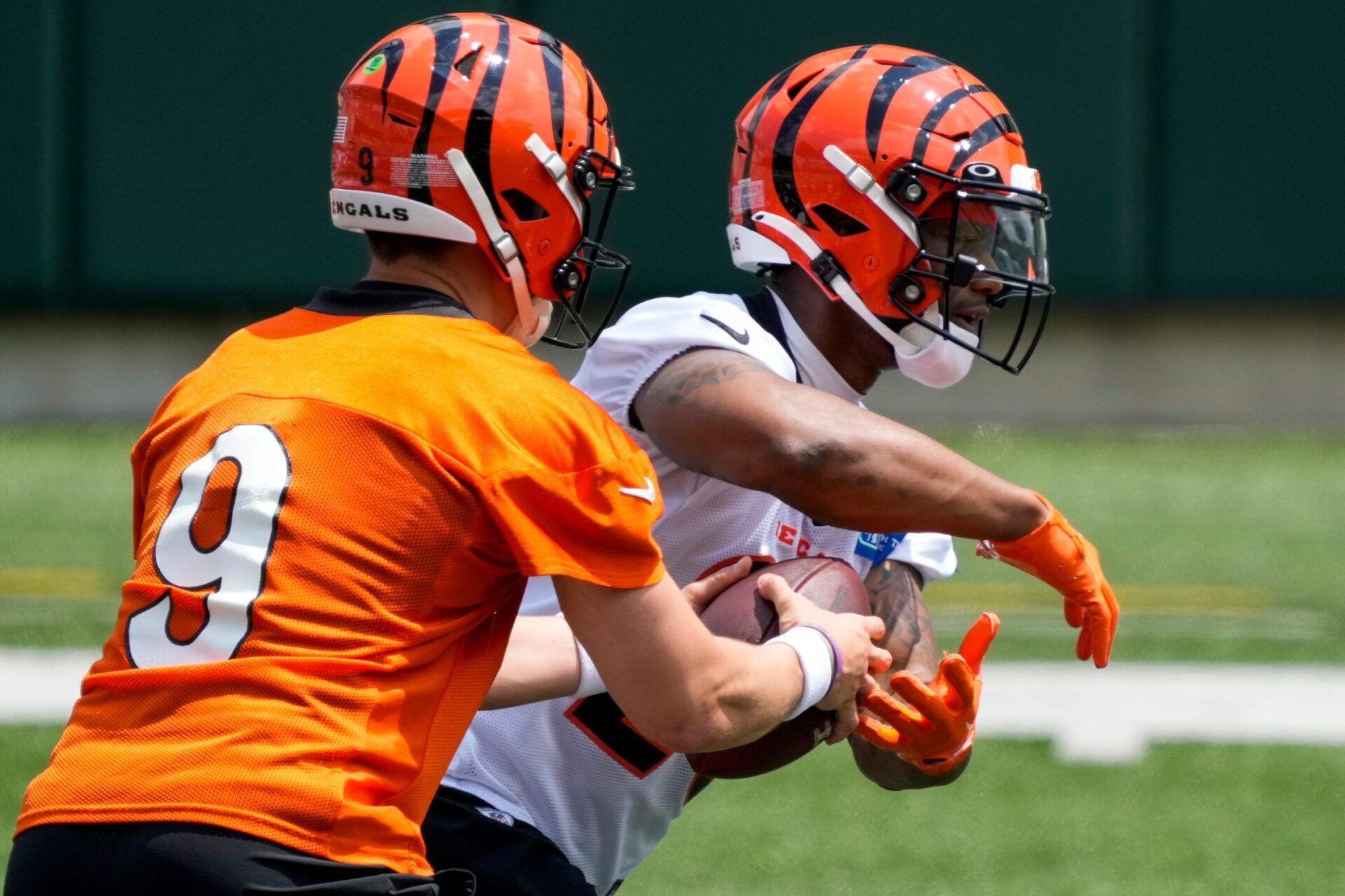 Joe Burrow (9) hands off to running back Joe Mixon (28) during an off-season workout inside Paycor Stadium in downtown Cincinnati.