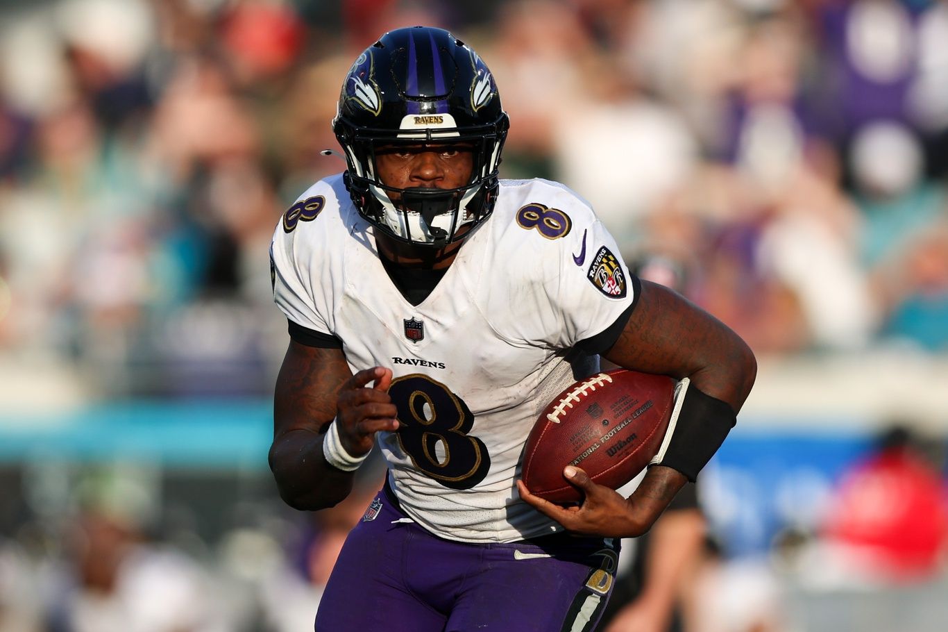 Lamar Jackson (8) runs with the ball against the Jacksonville Jaguars in the fourth quarter at TIAA Bank Field.