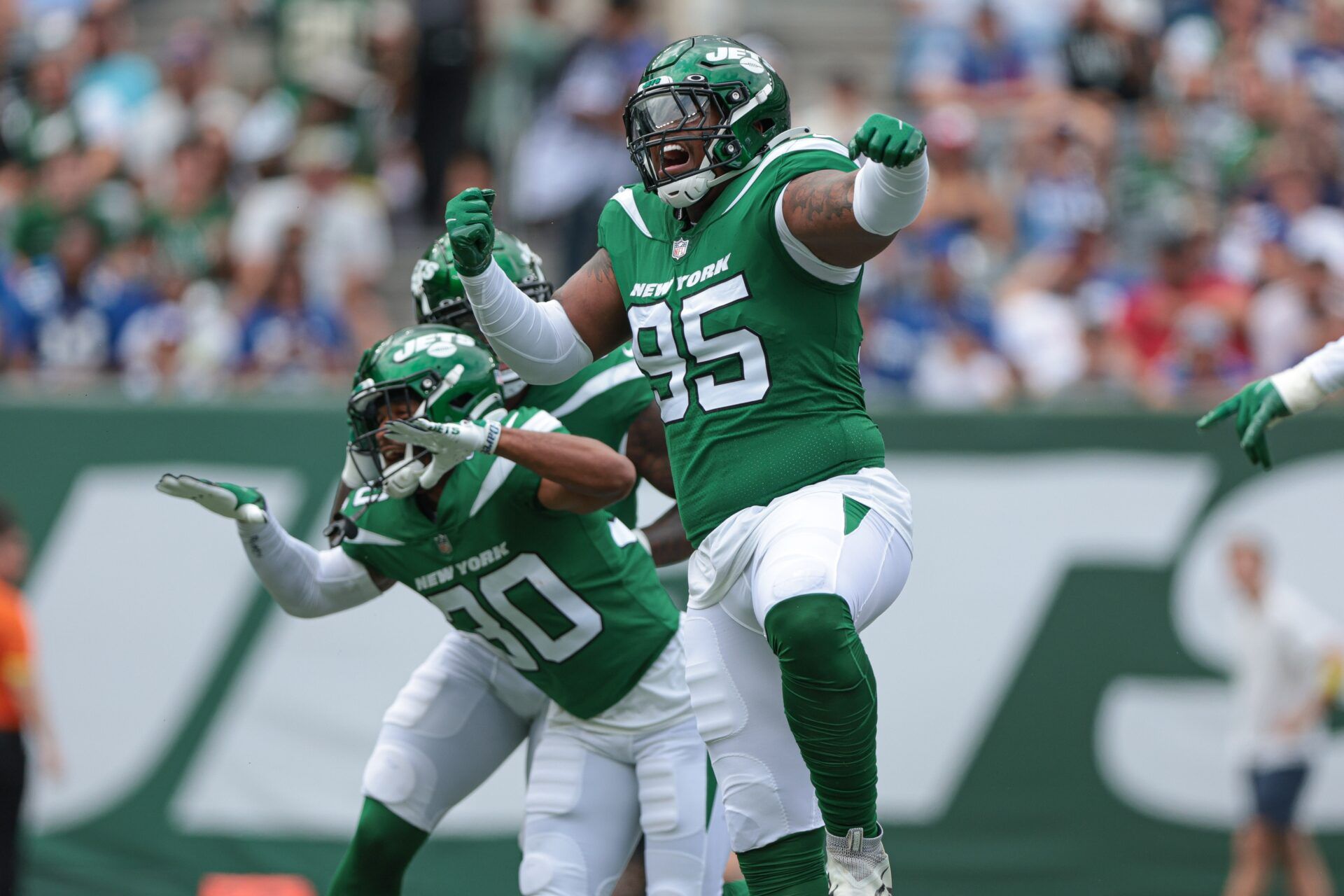 Quinnen Williams (95) celebrates his sack with cornerback Michael Carter II (30) during the first half against the New York Giants at MetLife Stadium.