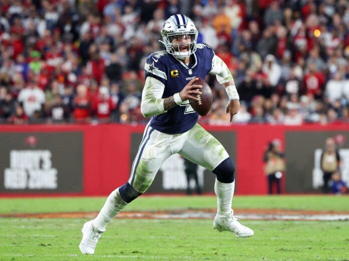 Dak Prescott (4) runs with the ball against the Tampa Bay Buccaneers in the second quarter during a wild card game at Raymond James Stadium.