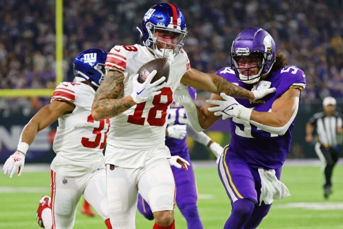 Isaiah Hodgins (18) runs with the ball against Minnesota Vikings linebacker Eric Kendricks (54) during the third quarter of a wild card game at U.S. Bank Stadium.