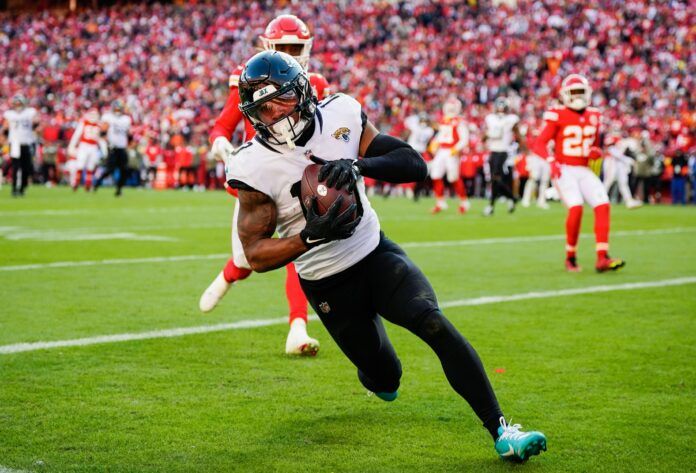 Christian Kirk (13) scores a touchdown as Kansas City Chiefs cornerback L'Jarius Sneed (38) defends during the second half at GEHA Field at Arrowhead Stadium.