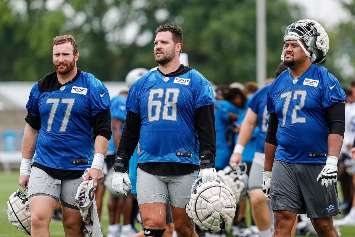 Frank Ragnow (77), offensive tackle Taylor Decker (68) and guard Halapoulivaati Vaitai walk off the field after practice during the first day of training camp.