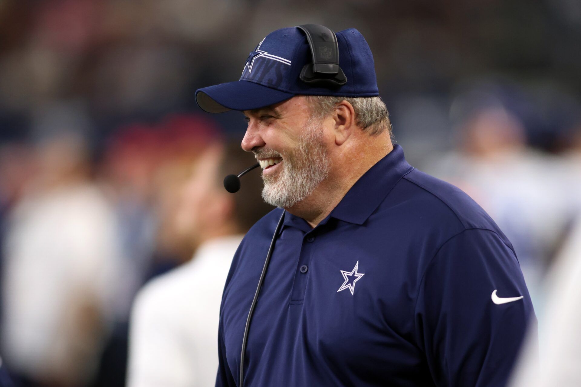 Dallas Cowboys head coach Mike McCarthy smiling during a game.