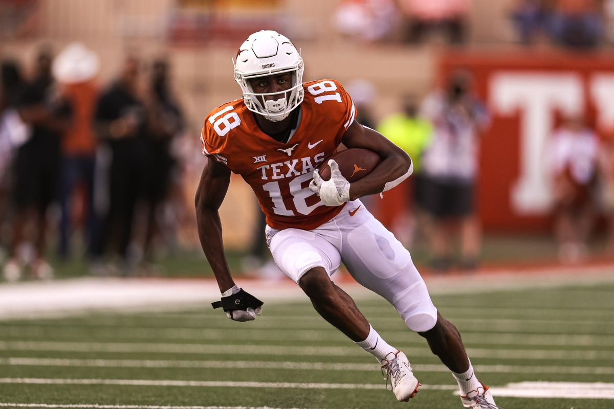 Texas wide receiver Isaiah Neyor (18) runs the ball during Texas's annual spring football game at Royal Memorial Stadium in Austin, Texas on April 23, 2022.