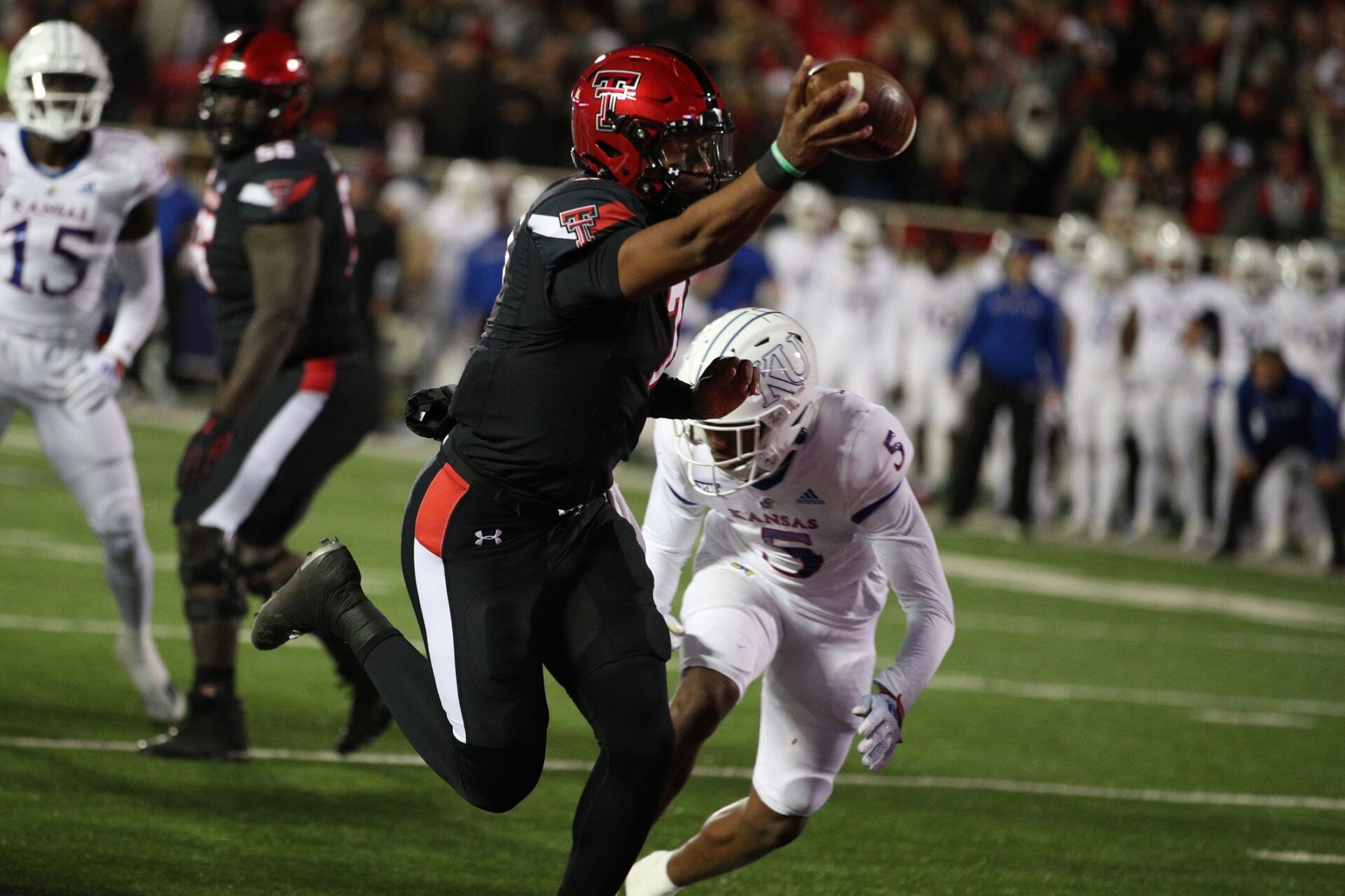 Texas Tech Red Raiders quarterback Donovan Smith (7) reacts after scoring a touchdown against the Kansas Jayhawks in the first half at Jones AT&T Stadium and Cody Campbell Field.