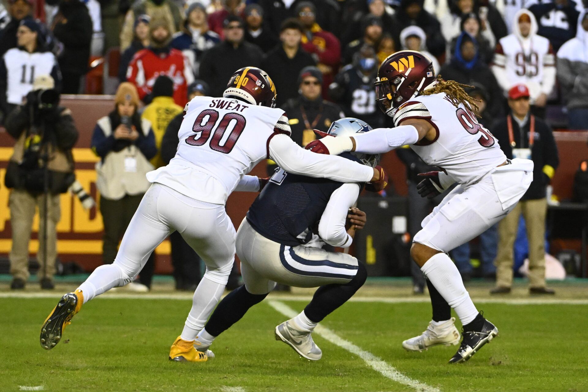 Washington Commanders defenders Montez Sweat (90) and Chase Young (99) sack Dallas Cowboys QB Dak Prescott (4).
