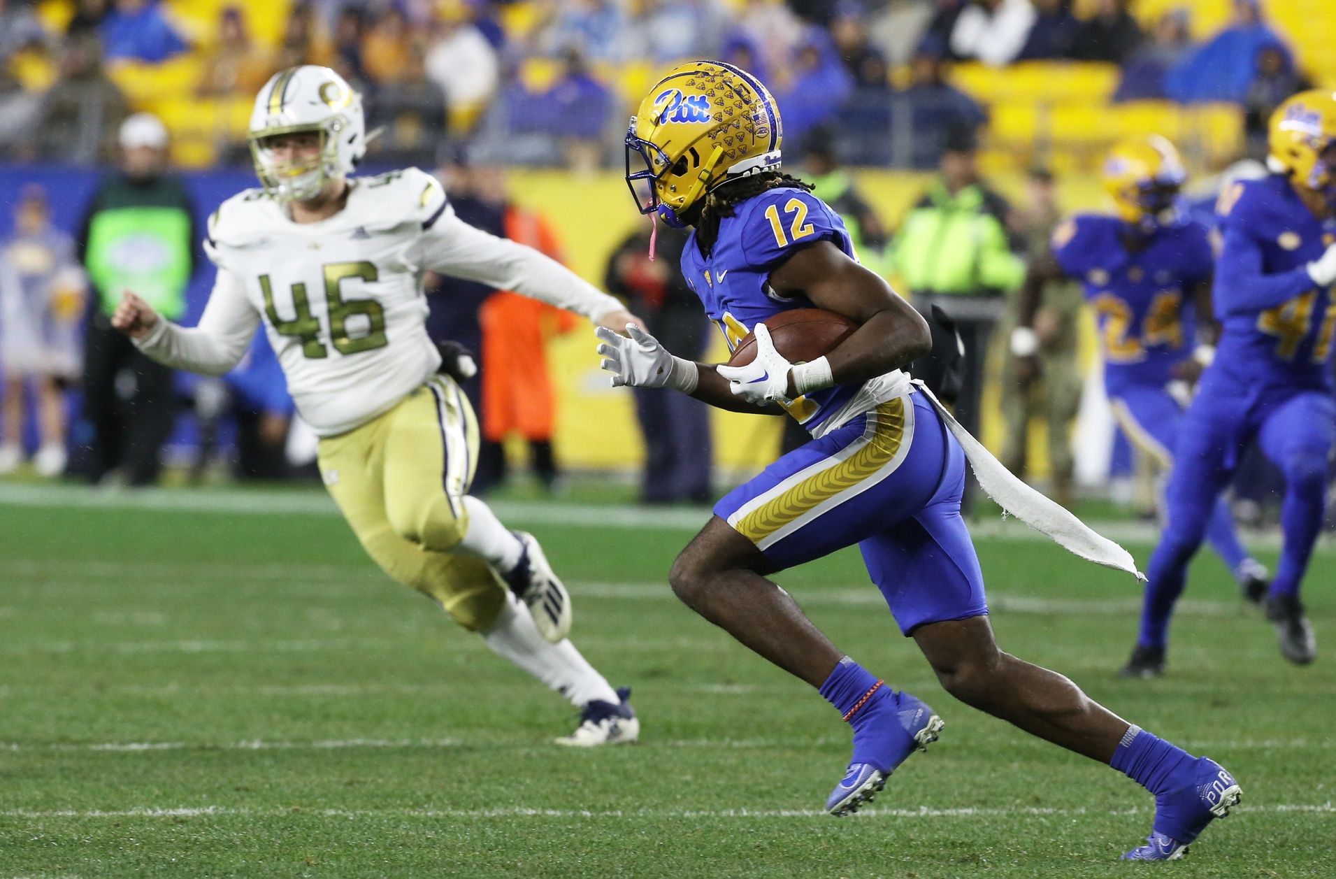 Pittsburgh Panthers DB M.J. Devonshire (12) returns a punt against the Georgia Tech Yellow Jackets.