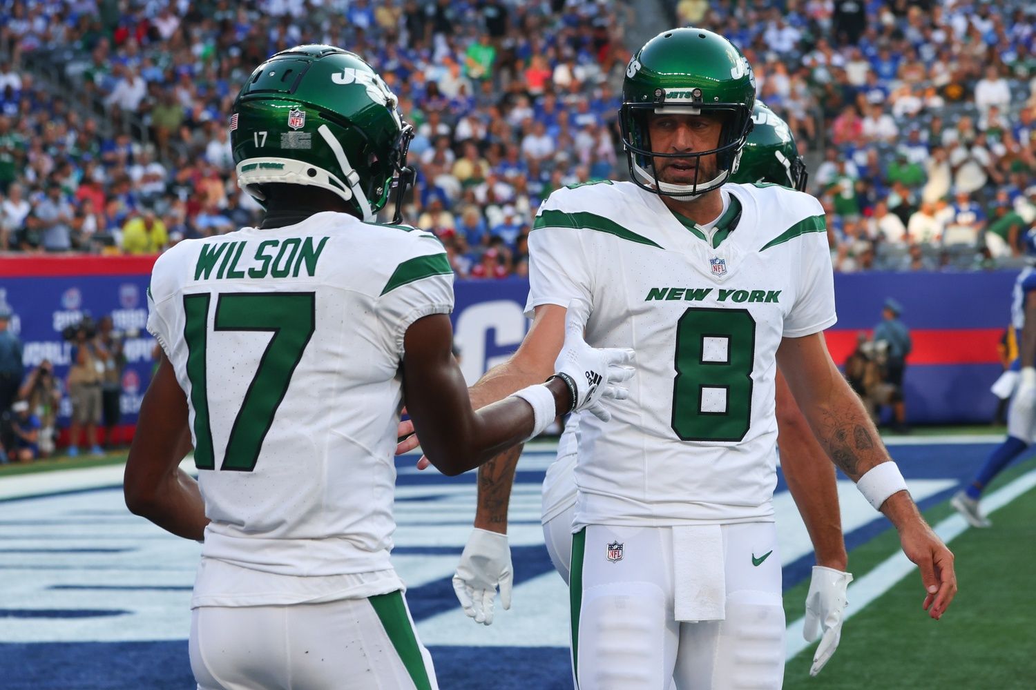 New York Jets QB Aaron Rodgers celebrates with wide receiver Garrett Wilson.