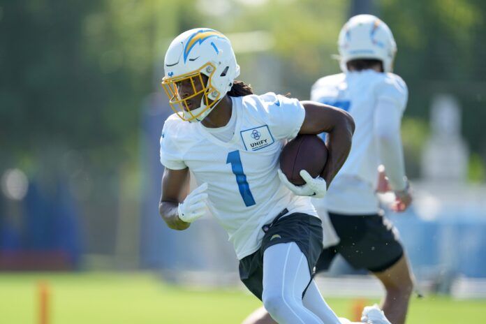 Los Angeles Chargers receiver Quentin Johnston (1) takes the handoff from quarterback Justin Herbert (10) during training camp at Jack Hammett Sports Complex.