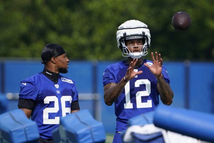 Saquon Barkley (26) and tight end Darren Waller (12) talk on the first day of training camp at the Quest Diagnostics Training Facility.