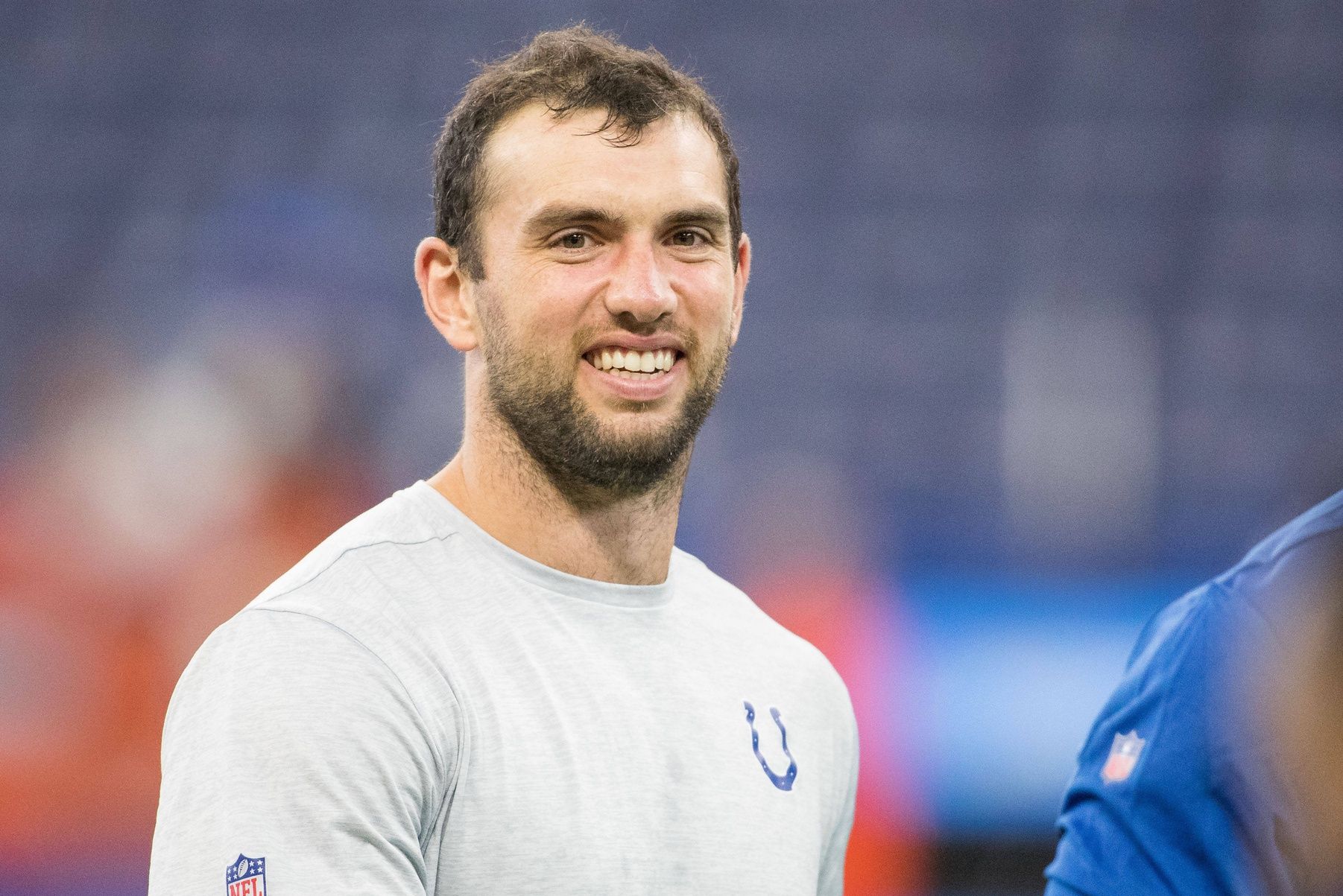 Andrew Luck (12) walks the field before the game against the Cleveland Browns at Lucas Oil Stadium.