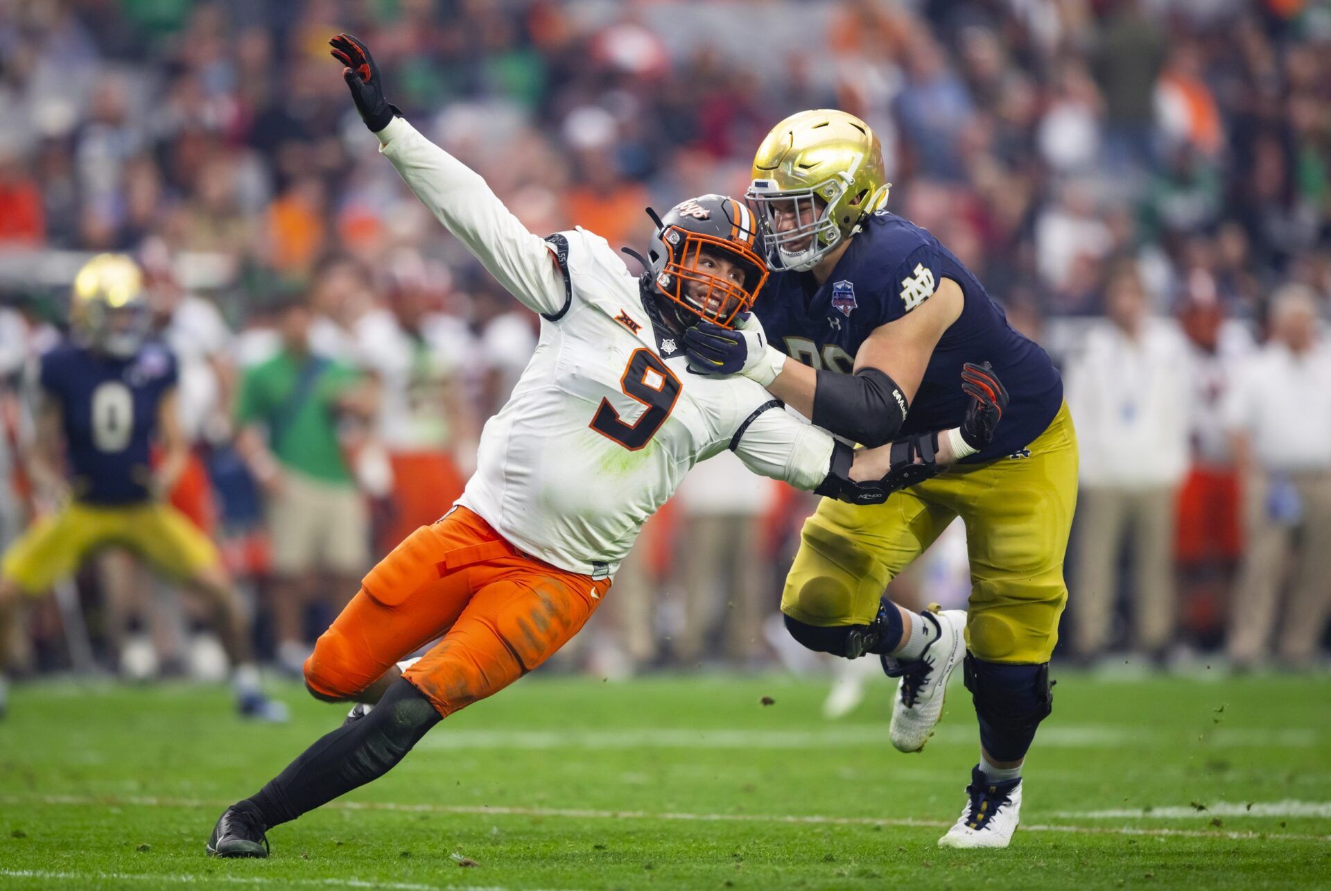 Notre Dame Fighting Irish OT Joe Alt (76) blocks an Oklahoma State Cowboys defensive end.