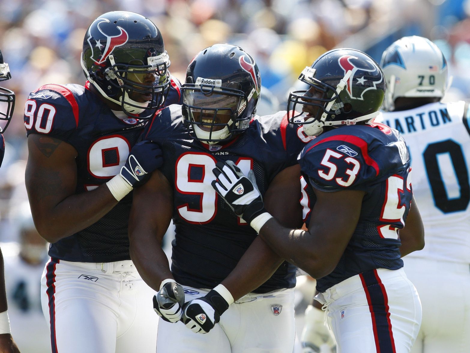 Amobi Okoye (91) reacts with Houston Texans defensive end Mario Williams (90) and Houston Texans linebacker Shantee Orr (53) after sacking Carolina Panthers quarterback Jake Delhomme (17) not pictured in the Texans 34-21 victory against the Carolina Panthers at Bank of America Stadium.