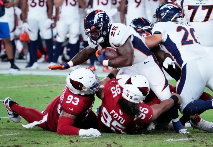 Samaje Perine (25) is tackles by Arizona Cardinals defensive tackle Leki Fotu.