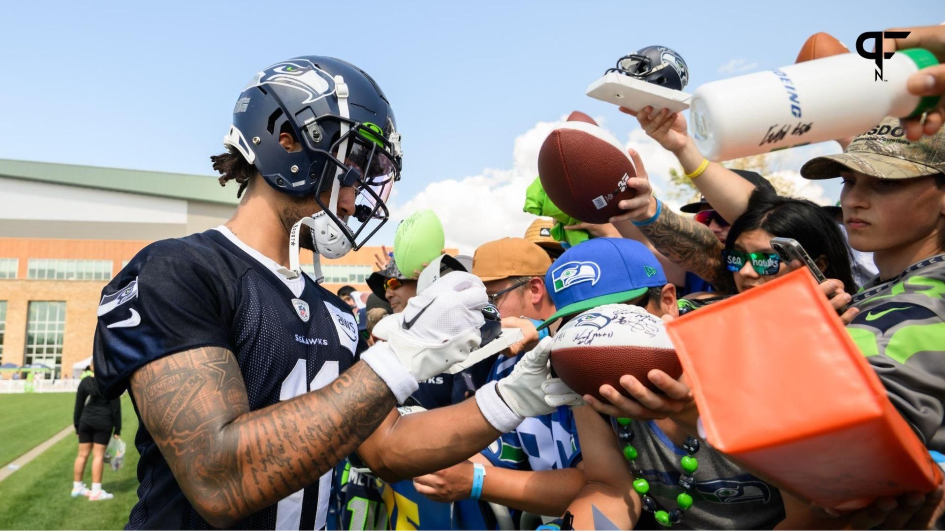 Seattle Seahawks wide receiver Jaxon Smith-Njigba (11) signs autographs after practice at the Virginia Mason Athletic Center.