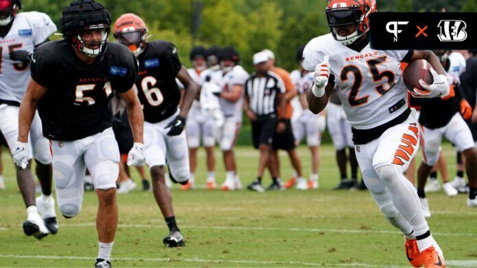 Cincinnati Bengals RB Chris Evans (25) rushes to the outside against the defense in practice.