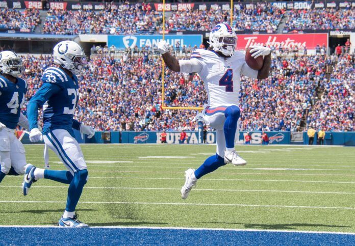 James Cook (4) beats Indianapolis Colts cornerback Dallis Flowers (33) to the endzone to score a touchdown in the first quarter of a pre-season game at Highmark Stadium.