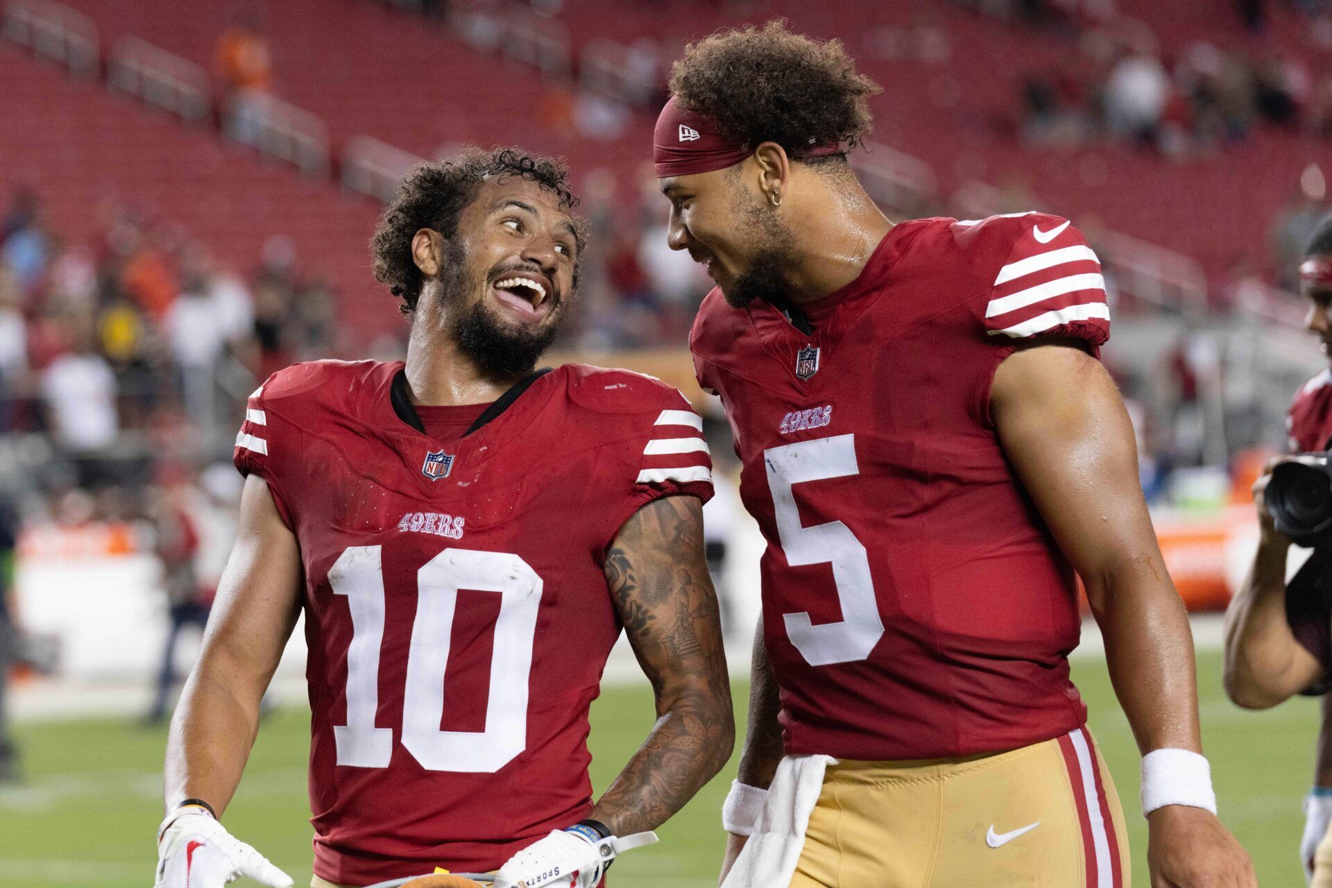 49ers wide receiver Ronnie Bell (10) and quarterback Trey Lance (5) laugh after defeating the Denver Broncos at Levi's Stadium.