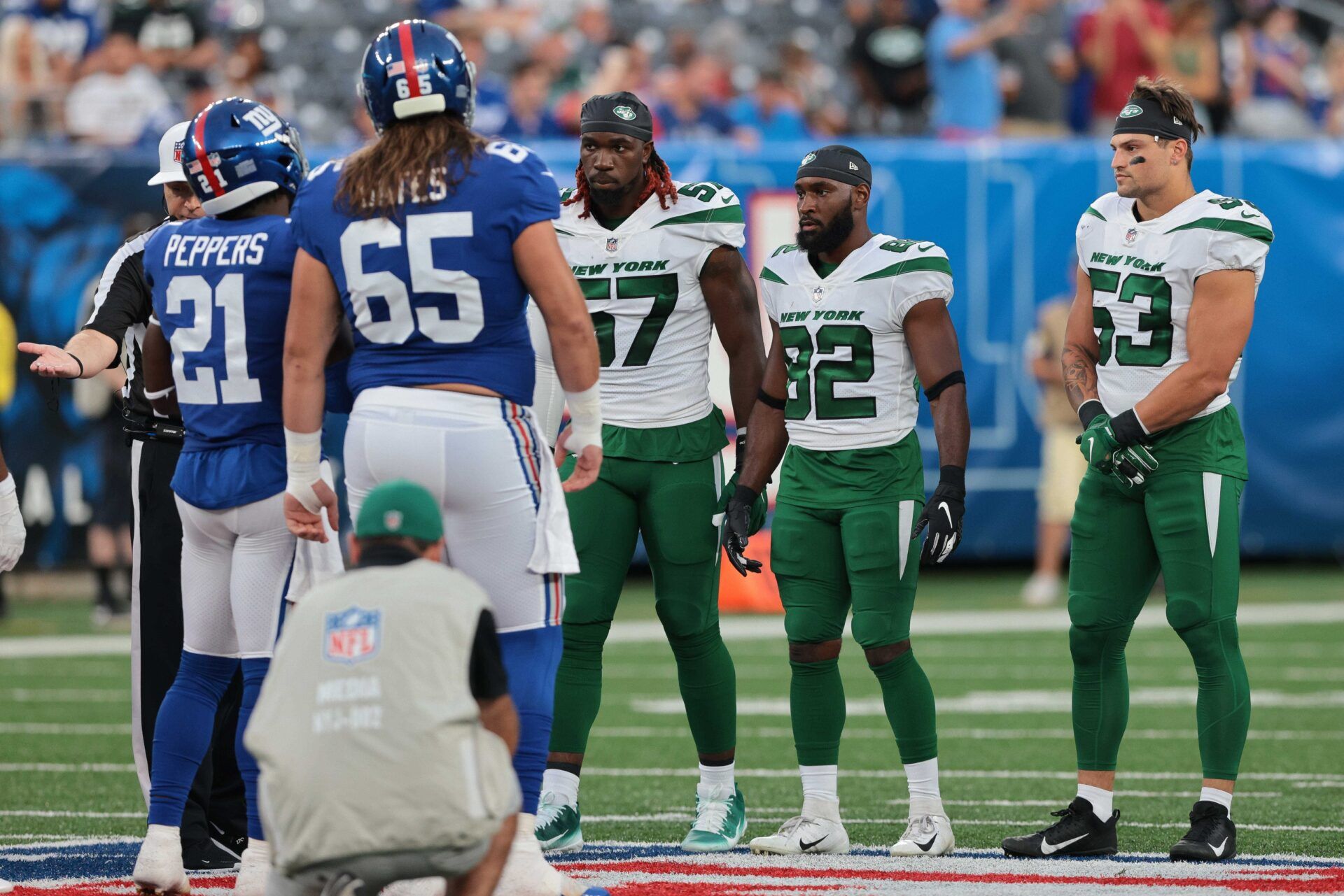 Jabrill Peppers (21) and center Nick Gates (65) meet New York Jets inside linebacker C.J. Mosley (57) and wide receiver Jamison Crowder (82) and linebacker Blake Cashman (53) for the coin toss before the game at MetLife Stadium.