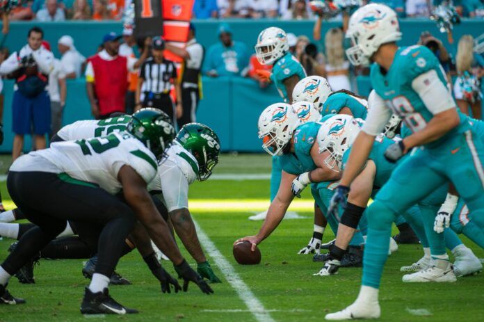 The Miami Dolphins face off against the New York Jets at the line of scrimmage.