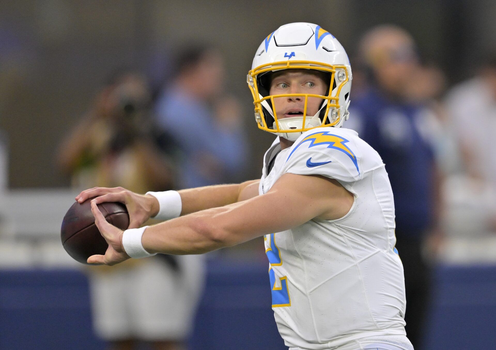 Los Angeles Chargers QB Easton Stick (2) looks to throw the ball deep.