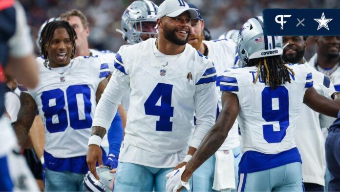 Dallas Cowboys quarterback Dak Prescott (4) laughs with teammates after a touchdown during the second quarter against the Jacksonville Jaguars at AT&T Stadium.