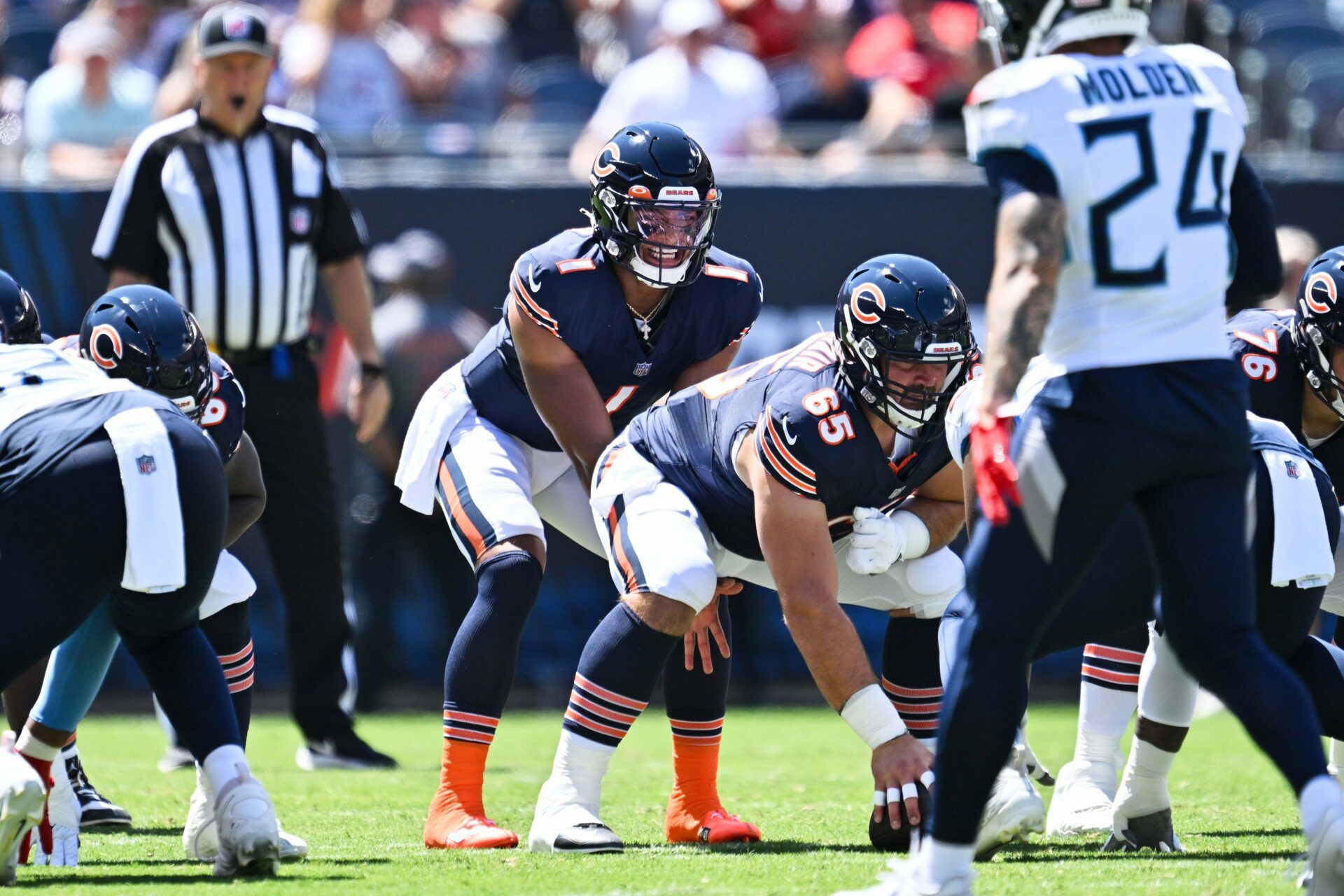 Justin Fields (1) calls signals against the Tennessee Titans at Soldier Field.