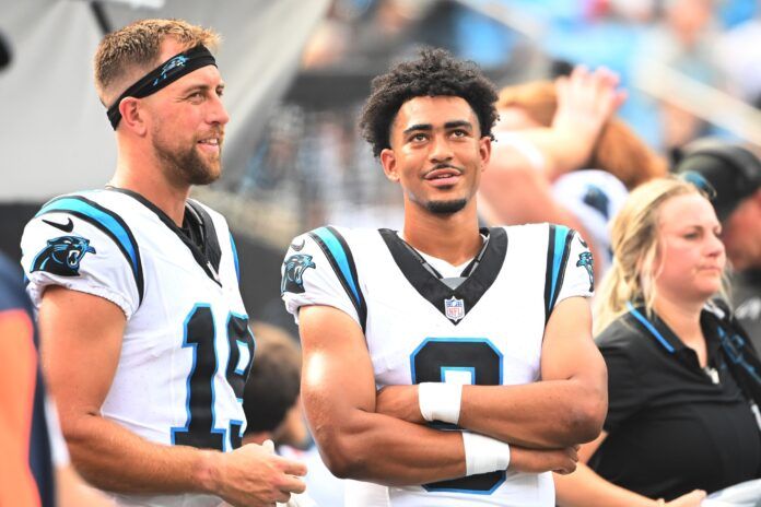 Adam Thielen (19) talks with quarterback Bryce Young (9) in the second quarter at Bank of America Stadium.