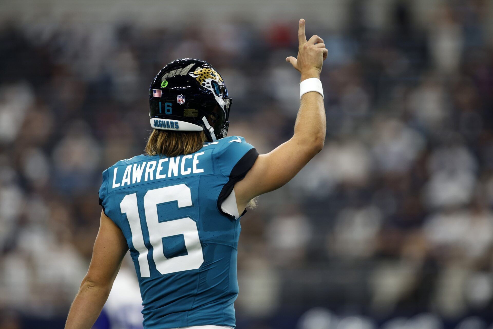 Jacksonville Jaguars QB Trevor Lawrence (16) walks on to the field.