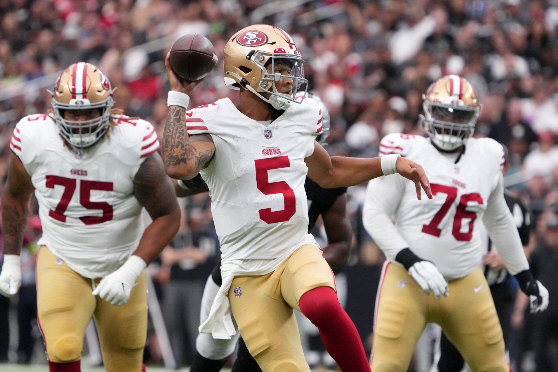 San Francisco 49ers quarterback Trey Lance (5) throws a touchdown pass against the Las Vegas Raiders in the first half at Allegiant Stadium